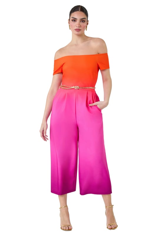 A-Ombre Bardot JSuit from Roman. Elevate your occasionwear this Summer with a vibrant ombre print jumpsuit! The perfect alternative to an occasion dress, this jumpsuit is cut in a flattering wide leg shape with culotte trousers and handy side pockets. Cinched in with a detachable metal belt, this ombre style has a striking gradient design and an even more flattering bardot neckline. Finishing off the shoulder with short sleeves, this stretch style has pleat details at the waist to create a feminine flow. Style yours with strappy heels for your next Summer event!
