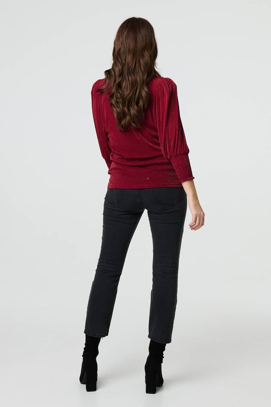 Dress for a smart-casual occasion with this glittery top. It has 3/4 puff sleeves and a hip length hem, along with a round neck and a relaxed fit. Just pair with fitted jeans and heels for the perfect laid-back occasion wear outfit.
