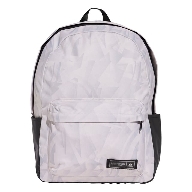 A classic pack with an edgy look. This adidas backpack lends fresh attitude to your casual outfits thanks to a cool allover print. Roomy enough for all your essential gear, it has a zip main compartment, front zip pocket and side slip-in pockets to keep everything organised. Padded adjustable straps add comfort if the bag gets heavy. This product is made with at least 50% recycled materials. By reusing materials that have already been created, adidas help to reduce waste and our reliance on finite resources and reduce the footprint of the products adidas make.  - Dimensions: 15 cm x 36 cm x 44 cm - Volume: 27.5 L - 100% polyester (recycled) - Zip main compartment - Front zip pocket - Side slip-in pockets - Padded adjustable straps  Shipped by adidas