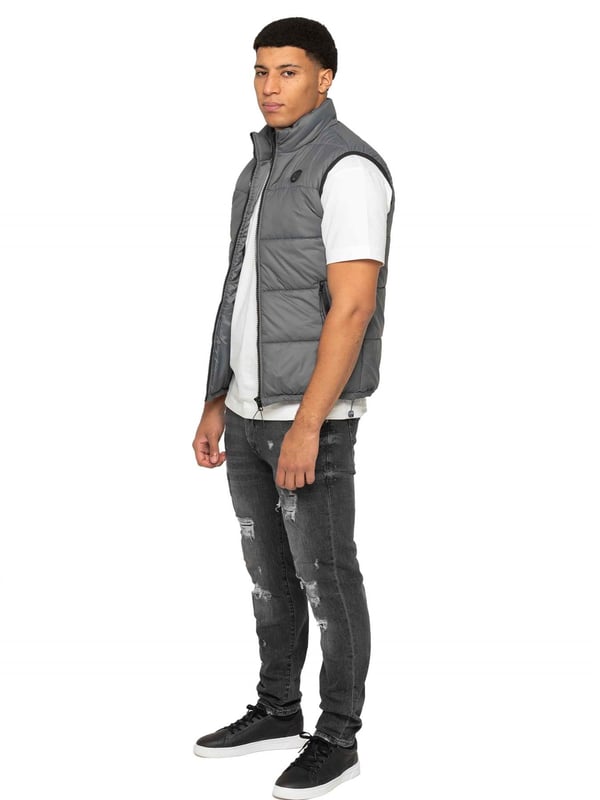 Embodying both fashion and function, the Enzo Mens Puffer Gilet boasts a water-resistant design and a high neck for added warmth. It also offers secure storage with zipped side pockets, and a custom fit with its elasticated hem and adjustable toggle. The full zip-up front and lined interior provide ultimate comfort and practicality. With a EZ branded badge on the chest, this gilet is crafted from durable 100% polyester and is conveniently machine washable.