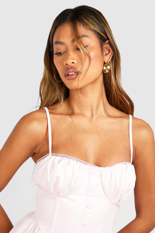 Sweetheart neckline for a feminine touch
        Adjustable spaghetti straps for a customised fit
        Fitted bodice with ruched detailing
        Flowy midi-length skirt for effortless movement
        Versatile design suitable for various casual occasions
    
    This charming midi dress from Boohoo is the perfect addition to your summer wardrobe. The sweetheart neckline and ruched bodice create a flattering silhouette, while the flowy skirt adds a touch of romance to your look. Style it with strappy sandals and a woven bag for a laid-back daytime ensemble, or dress it up with wedges and statement earrings for a garden party. The adjustable straps ensure a comfortable fit, making it ideal for long days out or family gatherings. This dress embodies the carefree spirit of summer, allowing you to look effortlessly chic whether you're brunching with friends or attending a casual outdoor event. Its versatility makes it a wardrobe staple that you'll reach for time and time again.