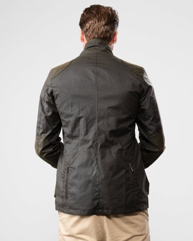Barbour Beacon Sports Wax Jacket
As this is a slim fitting jacket, we would advise purchasing the next size up than you would normally choose. The three-pocket waxed Beacon Sports jacket is an iconic blazer-style button through, inspired by the sought-after, limited edition To Ki To Sports Jacket. Effortlessly stylish and easy to wear, the Beacon Sports Jacket is a mediumweight waxed cotton jacket featuring soft leather-bound cuff edges, shoulder and elbow patches, two zipped rear pockets and a button-up throat flap. Lined with Barbour tartan, this jacket reflects traditional Barbour elements, with classic hip-height bellows pockets and a single chest pocket. This jacket is surprisingly versatile, and looks great worn as a blazer with the collar folded down and lapels open, or with the collar turned up worn over a fine-knit jumper and scarf for a contemporary country look.

Tailored Fit
Barbour tonal embroidery to left pocket
Outer: 100% cotton (waxed)
Lining: 100% cotton
Trim: 100% wool
6oz waxed cotton
Do not wash
Sponge clean only
Back length: 69cm - 81.5cm

MWX0007