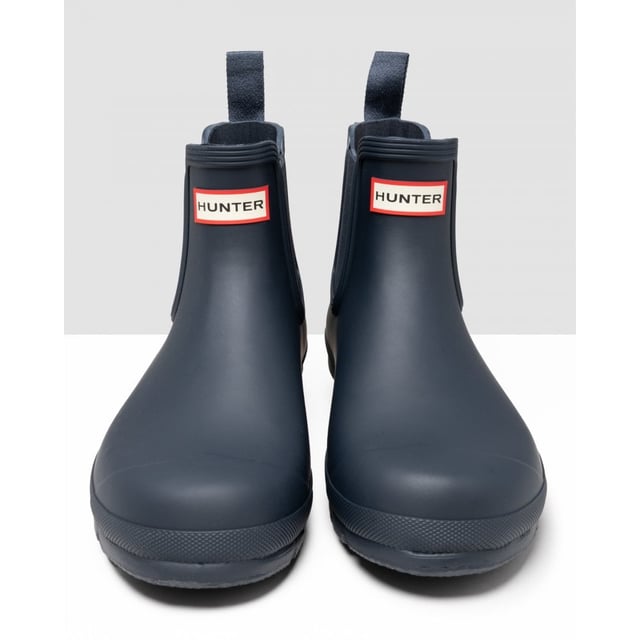 Size/Fit Summary: True to size, Regular fit which features new engineered improvements. If you are in-between sizes or want to wear a thick sock, it is recommended to size up.
The Hunter Original Chelsea Boot has been re-engineered for an improved fit and all-day comfort. A wider ankle circumference, and an increased curve in the heel and around the Achilles tendon delivers an even more comfortable fit.
The new and improved Hunter Original Chelsea Boot has an even more optimum fit to maximise all-day comfort. Ready for rain, each boot is handcrafted from natural rubber and vulcanised for superior protection. Retaining the iconic features of a traditional Chelsea, it features elasticated-gussets and has a nylon pull-tab to make stepping into the boot easy. In a classic black matte, these men's waterproof Chelsea's are a wet weather wardrobe essential.
We recommend that all Hunter Chelsea boots be worn with Hunter Chelsea socks, which have been technically designed to protect the wearer's skin from contact with rubber in specific areas.

Waterproof
Handcrafted
Waterproof
Polyester lining
Rubber outsole with Hunter Original tread pattern
Elastic side gussets and nylon pull-tab
Crafted from natural vulcanised rubber with a matte finish