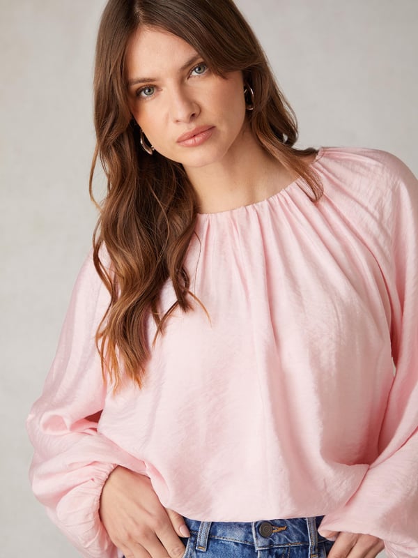 Co-founders' Notes

Our Pink Blouson Sleeve Top is a stylish blend of comfort and sophistication. Crafted from a lightweight viscose blend with a soft crinkle texture, this top ensures breathability and ease of wear. The elasticated cuffs and blouson sleeves add a touch of style, while the elasticated bubble hem bodice, finishing at the top of trousers, creates a flattering silhouette. Fully lined for optimal comfort, this top seamlessly combines fashion and functionality for a versatile wardrobe staple.

Bubble Hem

Fully Lined
Crinkle Texture Fabric
Loose fit. Try your usual size



Fabric &amp; Care



Composition: Main: 86% Viscose 14% Nylon Lining: 100% Viscose


Garment Care: Machine washable



Size &amp; Fit


Loose fit. Try your usual size

Length: 48cm (size 10)

Model is 170 cm/5'7" and is wearing a size 10