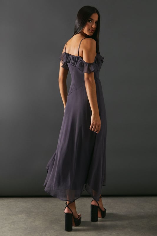Add a touch of elegance to any occasion. With its embellished asymmetric ruffle and strappy design, it offers a unique and stylish look. The midaxi length adds a modern twist, making it perfect for both casual and formal events.