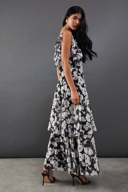 Strappy chiffon midi dress with bold floral print
        Layered tendril design for added movement and dimension
        V-neckline with delicate spaghetti straps
        Cold-shoulder detail with fluttery sleeves
        Tiered skirt with asymmetrical hemline for a dramatic silhouette
    
    Make a statement at your next night out with this captivating floral chiffon midi dress. The striking print and layered tendril design create a mesmerising effect as you move, ensuring all eyes are on you. The strappy neckline and cold-shoulder detail add a touch of allure, while the tiered skirt with its asymmetrical hemline offers a contemporary twist on a classic silhouette. Perfect for cocktail parties or dancing the night away, this dress pairs beautifully with strappy heels and statement earrings. For a more relaxed look, throw on a leather jacket and ankle boots. The versatile design allows for endless styling options, making it a go-to piece for various occasions. Whether you're heading to a rooftop bar or a trendy restaurant, this dress will help you radiate confidence and style.