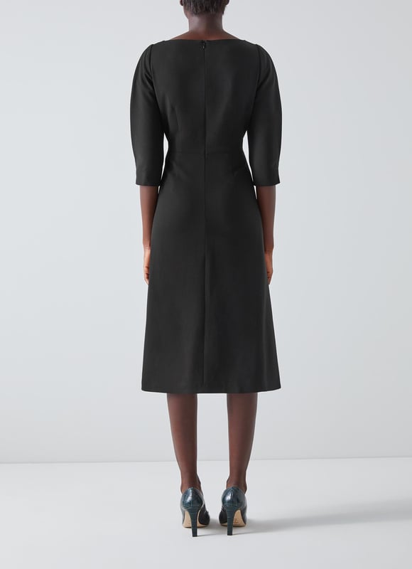 A chic everyday style designed to effortlessly take you between seasons, our Lemoni dress sits in our LKB Conscious collection thanks to its recycled fabric content. Crafted from a black crepe made from a blend of fabrics including recycled polyester*, it has a round neck, pleated three-quarter length sleeves, a nipped waist and a full skirt which falls to just below the knee. Wear it with a pair of courts for the office or with platform heels for parties.   *More about recycled polyester This garment is made from a conscious blend of fibres, including polyester created from recycled plastic bottles. Produced responsibly, using a special process which doesn’t exhaust natural resources, it creates a beautiful fabric which looks and feels great, and helps to reduce our impact on the planet.