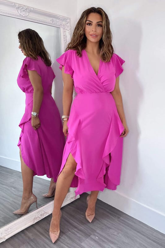Our Cerise Frill Detail Double Split Skirt Midi Dress is right on trend this season! Featuring a v neck wrap top, short frill sleeves, a frill detail double split skirt and a zip up back.  Style with heels and a matching bag.   Model wears: UK 8/ EU 36/ US 4 Model's height: 165cm/ 5'5" Approx length from centre back to hem: 134cm Fabric composition: 100% Polyester Colour: CERISE