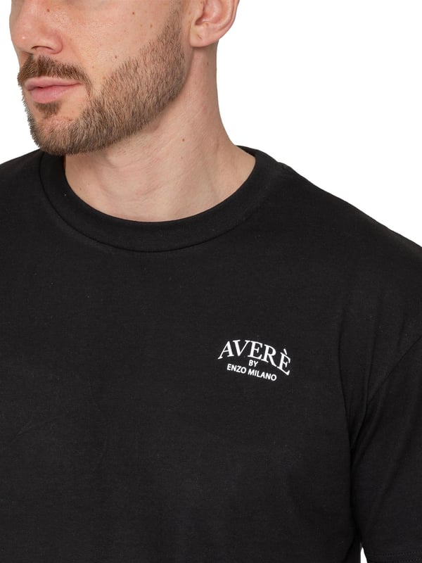 Introducing the Averè by Enzo Milano Oversized T-shirt. Crafted for both style and comfort, this T-shirt features a relaxed fit, ideal for everyday wear. The front displays a subtle Averè logo on the chest, while the back boasts a bold, large-scale Averè branding with "Enzo Milano" text, giving it a contemporary and trendy vibe. Made from soft, breathable fabric, this loose fit, crew neck t-shirt is perfect for pairing with jeans or shorts, offering an effortlessly casual yet stylish look. Ideal for those seeking comfort with a fashionable edge