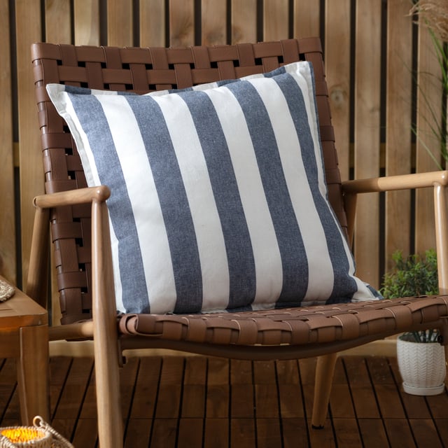 Elevate any outdoor space with the Hayle Cotton Outdoor Cushion, designed for both comfort and style. Crafted from soft-touch material treated for outdoor use, this cushion effortlessly blends durability with style. Its reversible striped design, featuring broad lines on one side and narrower ones on the other, allows for seamless transformations of outdoor settings. The water-resistant properties ensure resilience through every season, offering functionality without compromising aesthetics. Perfect for those seeking timeless, natural materials that enhance the ambiance of outdoor environments.