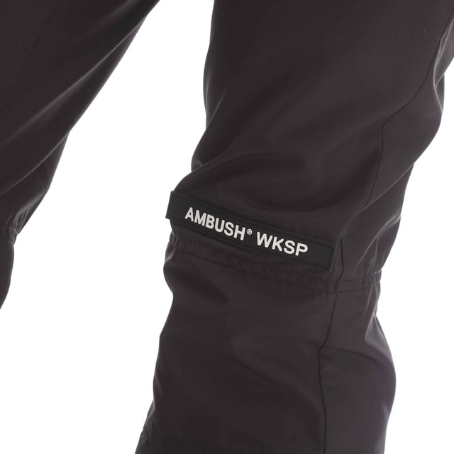 Womens Ambush Nylon Pants in black.- Zip fly fastening with hook fastening.- Zip pockets.- Printed branding.- Elasticated cuffs.- Ankle zips.- Straight leg.- 83% Cotton  17% Polyester.- Ref: BWCA0340011010
