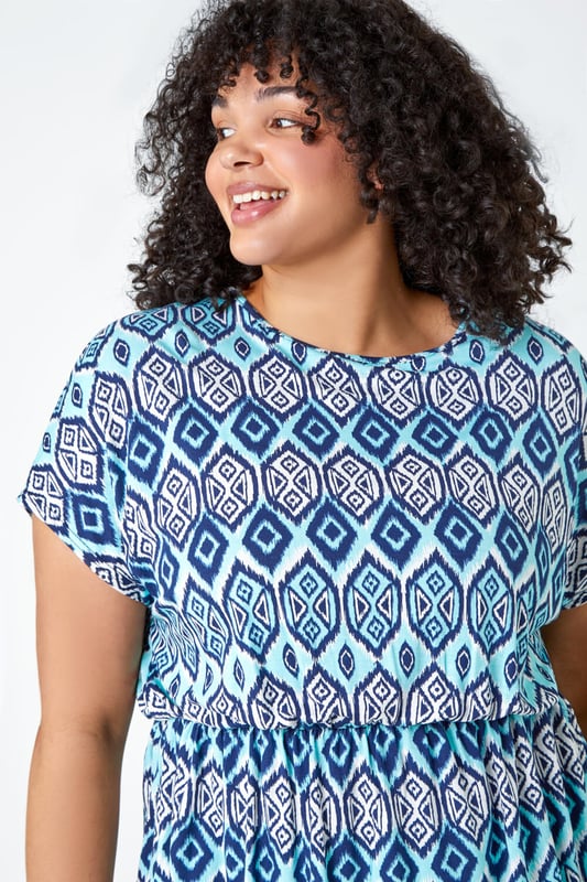 Curve Aztec Print Stretch Top from Roman. Top of the tops, this trendy tunic top is sure to become a favourite. Ideal for Spring, this Curve blouse has a flattering fit and flare shape with a comfortable elasticated waist. The bold aztec print is getting us holiday ready whilst the classic short sleeve shape keeps you cool all Summer long. Style with cropped stretch trousers and sandals for jet-set-ready styling this season.