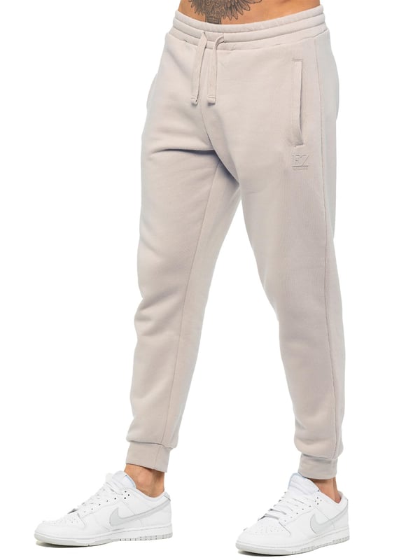 Experience ultimate comfort in our Enzo Mens Regular Fit Joggers. Made with a soft brushed back inner fleece lining, these joggers are perfect for casual wear. The cuffed leg design and elasticated waist with drawstrings provide the perfect fit. With 2 side slash pockets, you can easily carry your essentials.