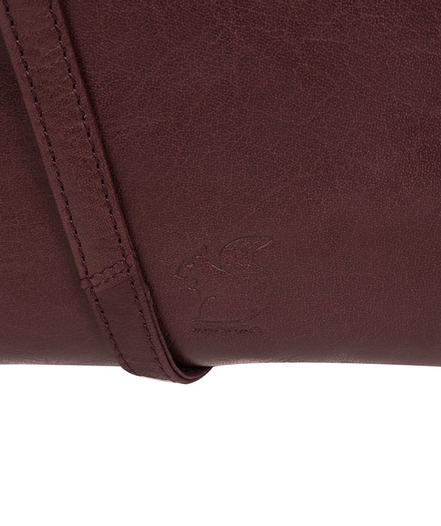 The 'Nikita' cross body bag from Conkca London is handcrafted from natural leather for a classic yet contemporary finish - perfect for elevating any look. With two full-length slip pockets on the exterior of the bag which arte perfect for on-the-go storage, complemented by a 100% cotton lining for a flawless finish. Comes with an adjustable leather strap and is adorned with the unimitable Conkca London squirrel logo and charm.