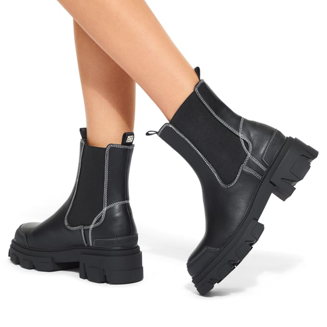 This KG Kurt Geiger Trekker Chelsea boot features a black upper with white stitching detail. There are two elasticated panels on the ankle.