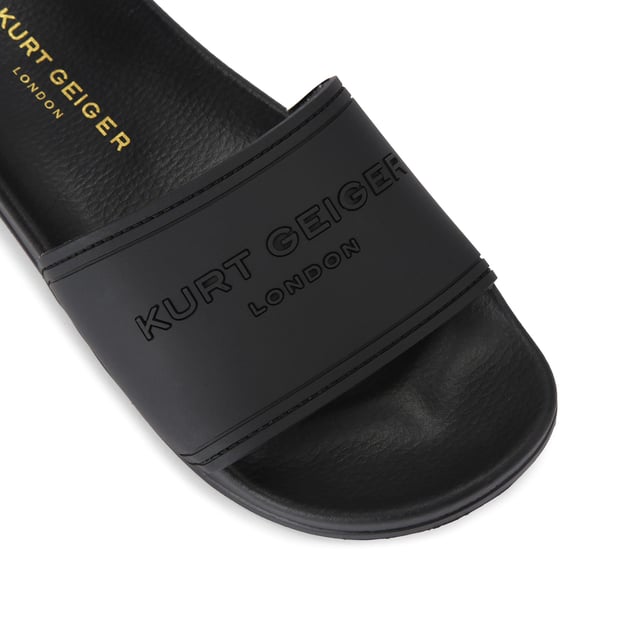 This Kurt Geiger drench Pool slider sandal is crafted from a black rubber. The wide foot strap is embellished with Kurt Geiger branding and the footbed is moulded for comfort.