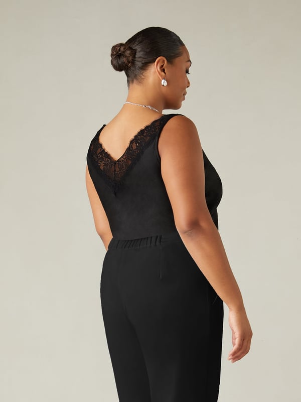 In classic black, this cami is made from the softest of satins and cut on the bias for a flattering fit. With an elegant lace neckline, it has bust seam detailing and flattering darts which create a cinched in silhouette. Its floaty, effortless shape and versatile design make this the perfect top for an evening out.