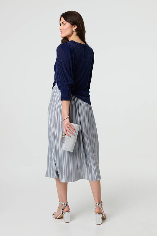 Dress for a smart-casual occasion with this glittery top. It has 3/4 puff sleeves and a hip length hem, along with a round neck and a relaxed fit. Just pair with fitted jeans and heels for the perfect laid-back occasion wear outfit.