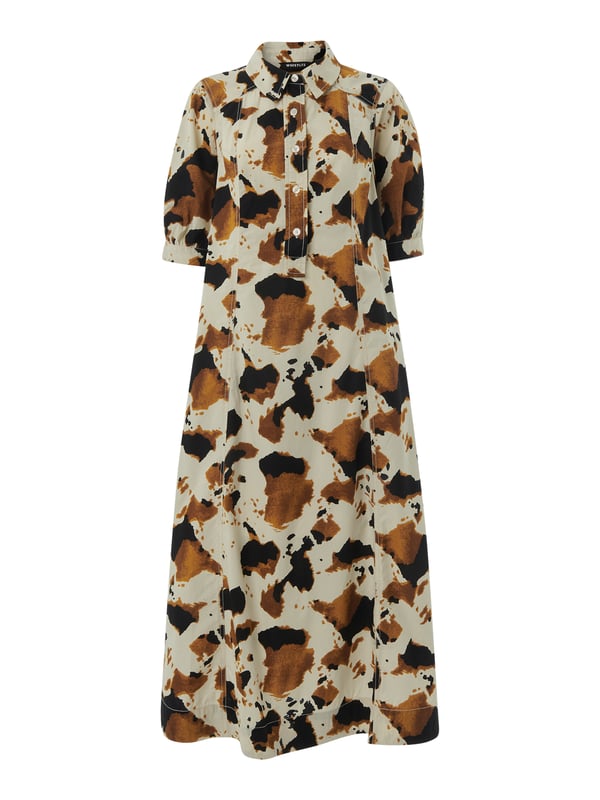 Embrace the statement look with our Cow Print Midi Shirt Dress, perfect for daytime flair or a casual weekend ensemble.