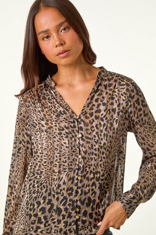 Petite Animal Print Button Up V-Neck Blouse from Roman. Add a touch of wild elegance to your wardrobe with our striking Petite animal print blouse. The collarless v-neckline and button-up details create a flattering look, while the long sleeves with shirt cuffs add a touch of sophistication. Designed in a comfortable woven fabric with gathered shoulders, finish with a denim jacket and jeggings for a trendy outfit!