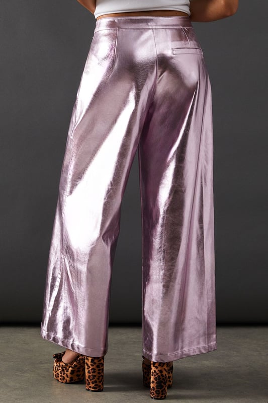 Eye-catching metallic finish for a bold statement
        Wide leg silhouette for a comfortable and trendy fit
        High-waisted design accentuates the waistline
        Front zip and button fastening for a secure fit
        Versatile style suitable for various occasions
    
    Make a dazzling entrance with these striking metallic wide leg jeans from Warehouse. Perfect for those who dare to stand out, these trousers combine comfort with high-impact style. The wide leg cut offers freedom of movement while creating a fashionable silhouette. For a night out on the town, pair these show-stopping trousers with a crisp white shirt, leaving it partially unbuttoned for a relaxed yet chic look. Add some platform sandals to elongate your legs and complete the ensemble with statement earrings. Whether you're hitting the dance floor or enjoying drinks with friends, these jeans will ensure you're the centre of attention. Their versatility also allows for more casual styling - try pairing with a simple black tee and trainers for an effortlessly cool daytime look that transitions seamlessly into evening wear.