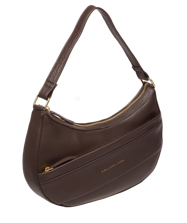 Crafted from high-quality Nappa leather, the 'Emma' grab bag from Pure Luxuries' Marylebone Collection is a must-have thanks to its unique silhouette. A crescent-shaped zip-over top secures the 100% cotton-lined interior which is complemented by two slip pockets - ideal for maintaining an organised bag. An angular zipped pocket adorns the front of the bag and is complemented by a slim leather strap with a drop length of 22cm. Gold-coloured metal fittings and zips elevate the classic design alongside the gold foil embossed logo.