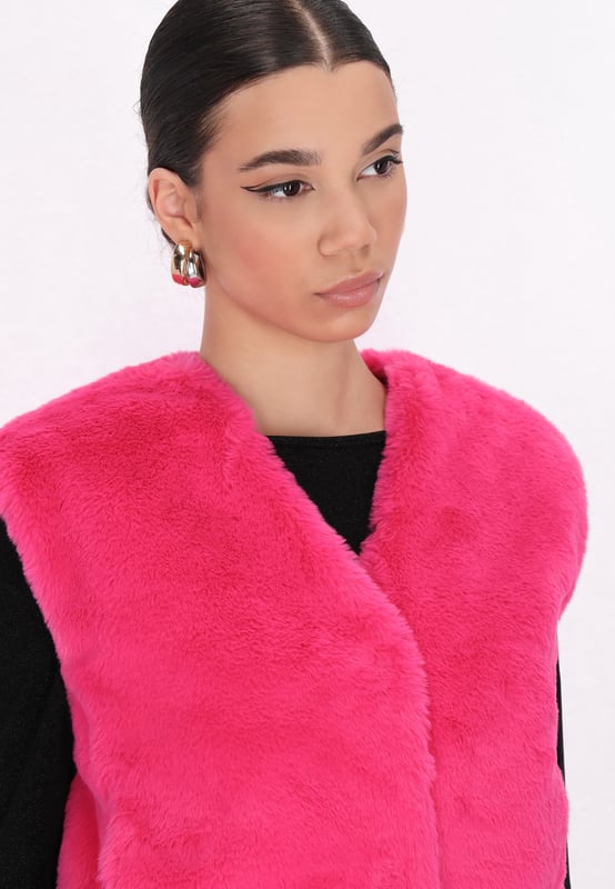 Geef je wintergarderobe een boost met dit funky, mouwloze vest met kort bont. De zachte buitenkant en binnenvoering zorgen voor warmte en comfort, perfect voor koude dagen. Met een V-hals, verborgen sluiting en rechte zoom biedt het een casual maar stijlvolle look. Dit wintervest is gemaakt voor een moderne jonge vrouw en houdt je het hele seizoen lang behaaglijk.  Waistcoat
