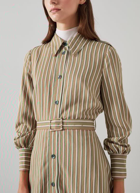 The shirt dress is an LKB sigture, and our new Frances dress takes on a utilitarian twist with feminine flair - and flare. Crafted in Europe from a sustaible viscose rich fabric in tan with green and white stripes, it's a classic collared, button-through style with horn-effect buttons, epaulettes to the shoulders, long sleeves with elegant cuffs, a bucked belt and a midi-length flared skirt. Wear it over a polo neck and long boots now, and shed the layers once the weather warms up.