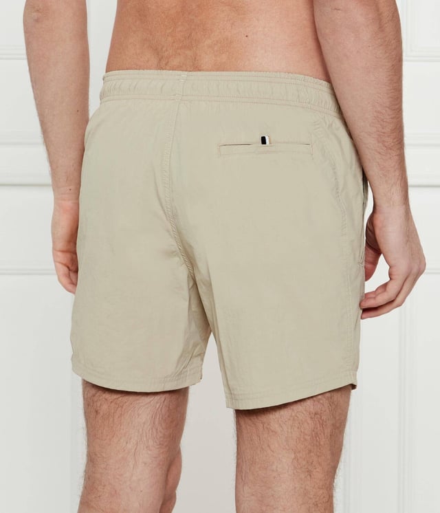 STYLE OCTOPUS – 50515296
Statement swim shorts with full lining by BOSS, designed in soft quick-drying poplin featuring a vertical logo print on the left leg. For our BETTER BOSS products, we always use at least 60% better raw materials. This product is made from at least 60% recycled polyamide. By using recycled polyamide, we aim to save resources by making use of existing plastic material. Recycled nylon is usually made from pre-consumer spinning or fabric waste and may also come from post-consumer industrial fishing nets. We only use raw materials with a verified chain of custody to ensure the use of certified recycled polyamide.
100% Polyamide (recycled), Lining: 100% Polyester
30°C fine wash
Do Not Bleach
Do Not Tumble Dry
Do Not Iron
Do not chemical dry clean
The model wears a size M and is 189 cm tall with a, 98 cm chest, 80 cm waist and 94 cm hips.
