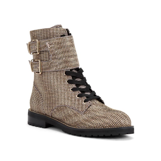 The Sutton ankle boot arrives in a beige houndstooth fabric topped with gold crystal embellishment. The front is laced up with two gold tone buckled ankle straps. Heel height: 3cm.