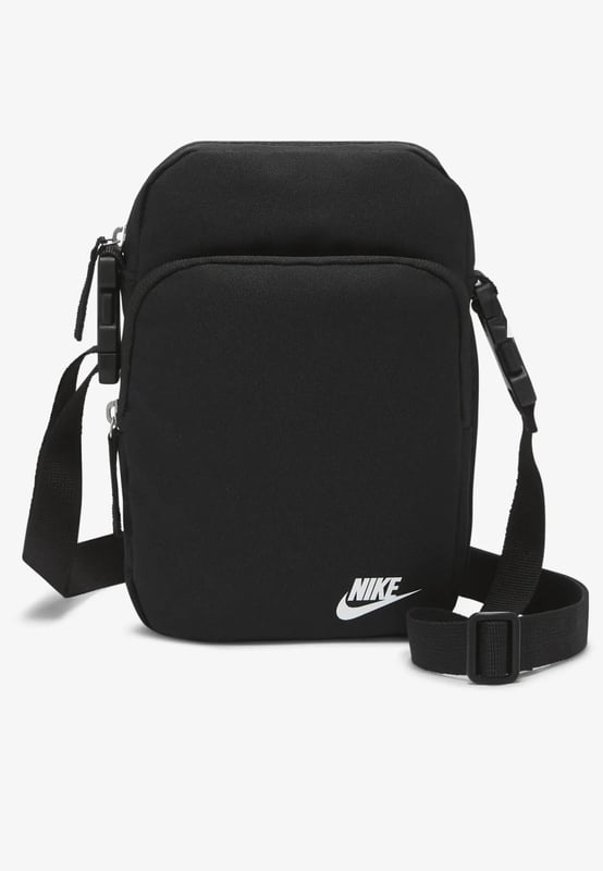 Nike Heritage Cross-Body Men Bag in Black A comfortable and easy-to-adjust strap makes taking the Nike Heritage Waist pack on everyday trips a no-brainer. - -. The main compartment provides secure storage for your phone, snacks or wallet, while the smaller accessories pocket on the back helps keeps things like your keys or travel info safe and close at hand. - -.  The buckle snaps together in the middle of the strap for a comfortable, easy-to-adjust fit. - -. The bag can be worn at your waist, across your body or over your shoulder. - -. Dual zip on the front pocket provides easy access to larger items. - -. Dual zip on the back keeps smaller items stored securely.