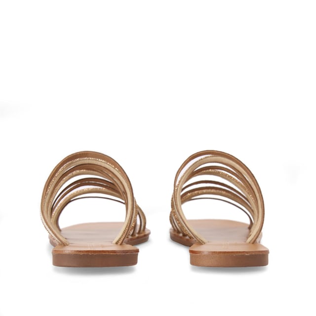 The Kurt Geiger Daisy Flat Sandal is a slip-on sandal. There are multiple gold straps across the upper each with its own metallic finish or crystal embellishment.
