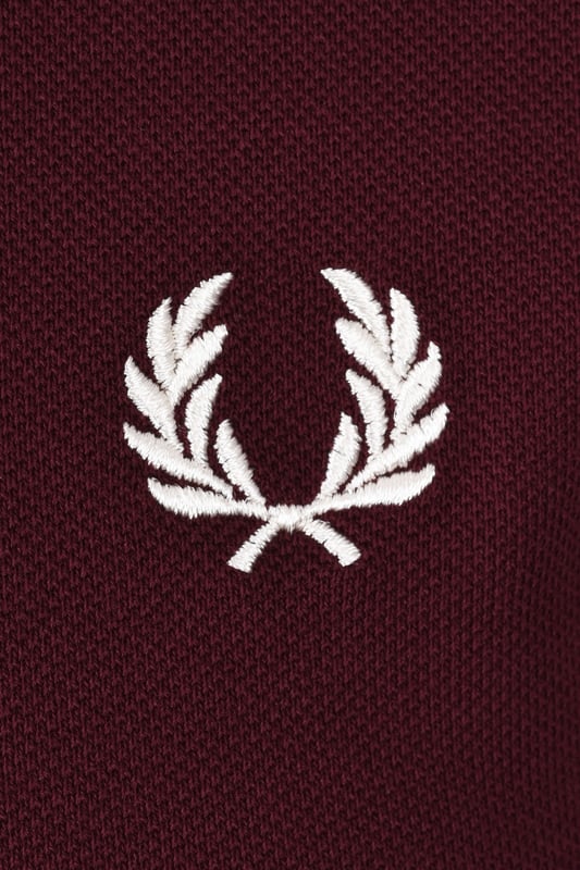 Fred Perry Twin Tipped Polo Shirt Oxblood
The classic twin tipped polo shirt by Fred Perry. In a dark red colourway with contrasting twin tipped detailing to the collar and cuffs it is a standout design. Crafted from cotton pique it is a quality piece comfortable for all day wear and can be easily styled with your favourite denim.

100% Cotton
Short Sleeved
Twin Tipped Collar and Cuffs
Two-Button Plackeet
Regular Fit
Embroidered Laurel Wreath
Style: M3600