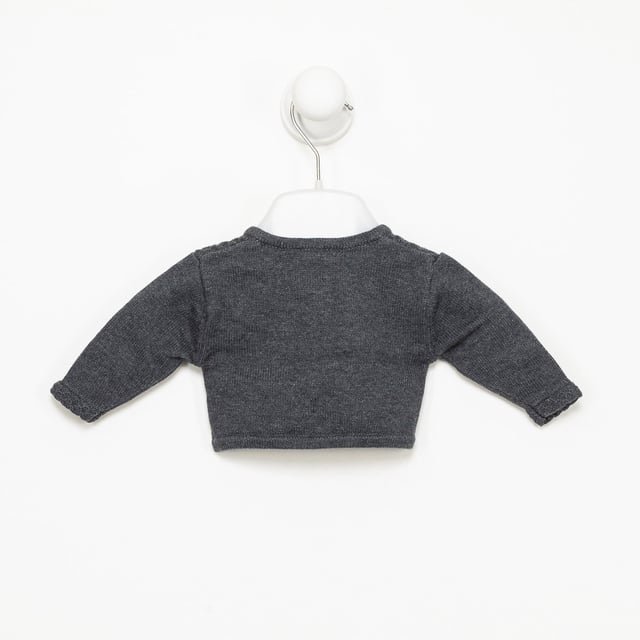 Tricot knit jacket.
 Closed round neck.
 Button closure on the front.
 Plate with the name of the brand on the lower side.
 Composition: 75% Cotton, 20% Polyamide, 5% Wool
 Care:
- Wash maximum at 30ºC.
 - Iron at medium temperature, max. 110ºC.
 - It is not allowed to use a dryer.
 - Do not use bleach.
 - Does not support dry cleaning.
