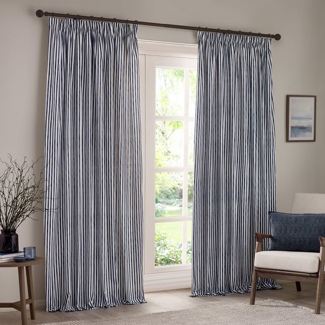 Transform your living space into a sanctuary with Hebden Striped Pencil Pleat Curtains. Crafted from 100% cotton, these curtains offer a soft, yet durable touch. The timeless, textured stripe design complements any minimalist or classic décor, while the room-darkening lining provides the perfect retreat from the outside world. Perfect for those who value natural materials, Hebden curtains are an investment in comfort and style, enriching your home environment without compromise.