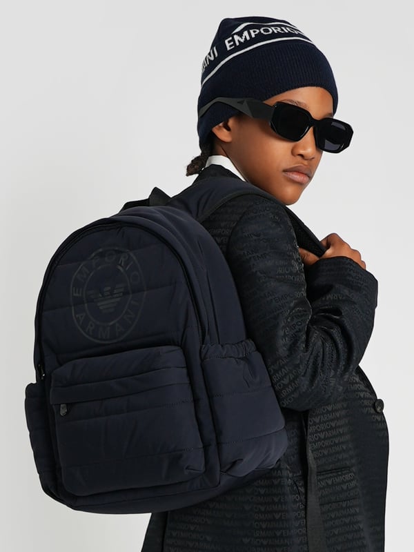 Elevate your young one's style with the Emporio Armani Boys Logo Backpack in Navy (37cm). Crafted for the AW2024 season, this chic piece blends functionality with high-end fashion aesthetics. Perfect for school or weekend adventures, here's why it's essential:‚ Iconic Armani Logo: Features the esteemed Emporio Armani logo, synonymous with luxury and quality.  ‚ Premium Navy Blue Fabric: High-quality material ensures durability and longevity.  ‚ Ergonomic Design: Adjustable straps and lightweight structure offer comfort and support for all-day wear.  ‚ Versatile &amp; Stylish: Timeless navy hue complements various outfits, elevating your boy's fashion game.Gift a touch of designer elegance to your young one's essentials. Get the Emporio Armani Boys Logo Backpack today!