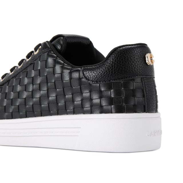 The Carvela Daze Weave trainer features a black upper with woven sides. The hardware is gold with embossed foil logo on the tongue.