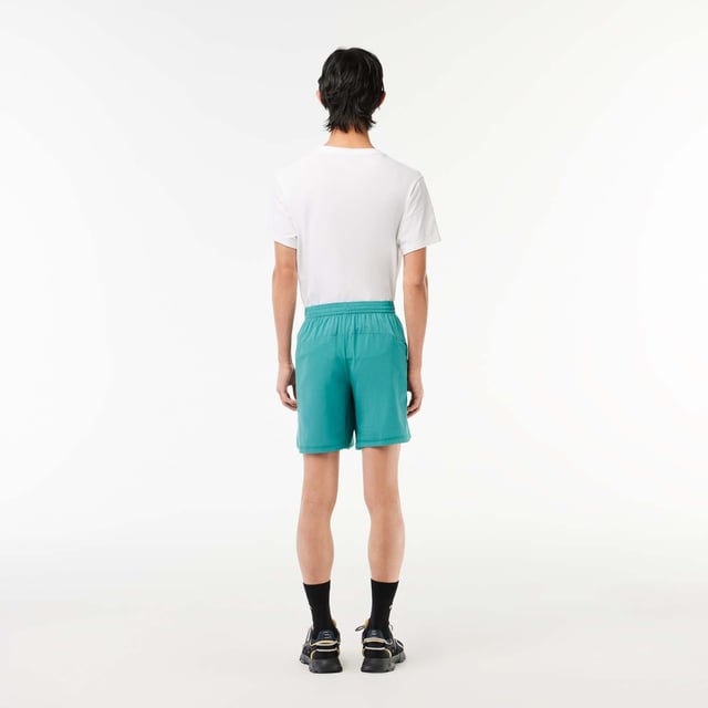 Men’s Lacoste Sport Check Stretch Mesh Shorts Relaxed  loose cut: Comfortable and fluid. Wide waistband with drawstring closure: Great for all body types. Zipped side pockets: Keep your essentials safe. Green silicone crocodile: The hallmark of excellence. Stretch taffeta and mesh: Breathable fabric for optimal ventilation.