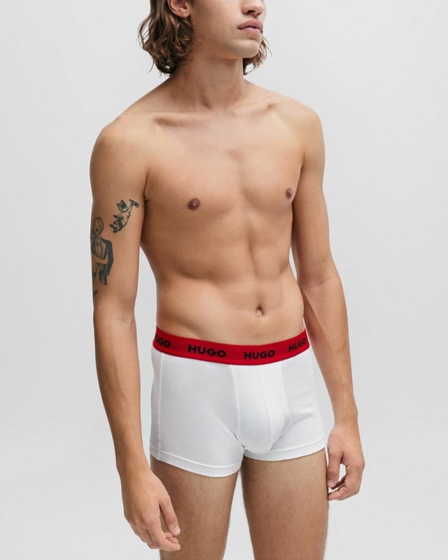 A trio of low-rise trunks by HUGO. Designed in breathable cotton blended with stretch for flexible comfort, these form-fitting trunks are topped with exposed waistbands carrying contrast logos in repeat. Update everyday foundations with this triple pack. 
95% Cotton, 5% Elastane
50469786