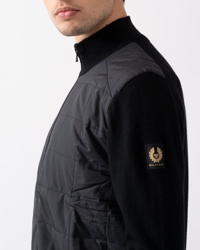 The Kelbrook zip cardigan. Inspired by military uniforms and made for updating your daily wardrobe, this boxy zip-through knit combines structured panelling with soft merino wool for an elevated finish.

Extra fine merino
Channel quilted shoulder reinforcement detailing
Ribbed cuffs and hem
Quilted mixed media body
Belstaff phoenix patch on left sleeve
Two-way zip centre front closure
Non-mulesed wool

Body: 100% wool, Woven: 100% polyester, Filling: 100% polyester
105303