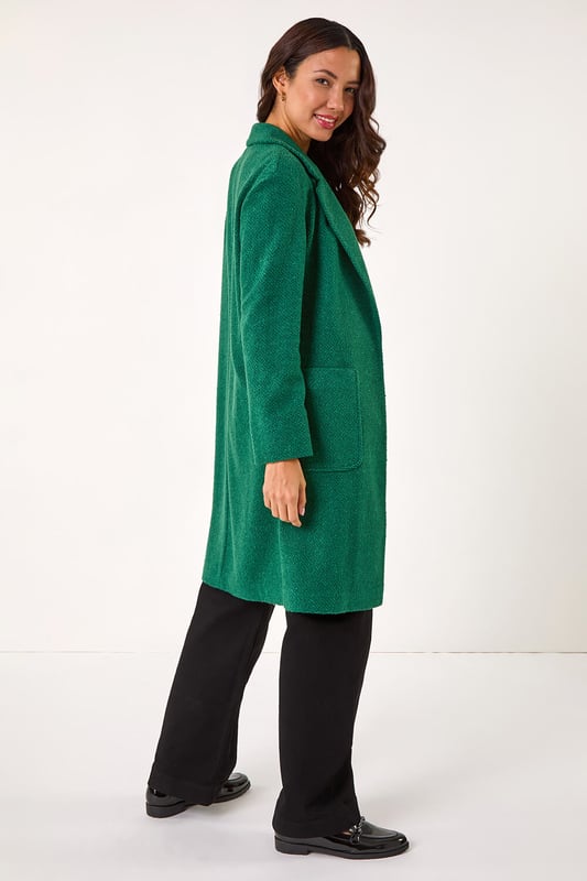 Boucle Knit Longline Coatigan from Roman. Add a timeless classic to your collection with this coatigan. Designed in a classic longline shape this piece features a relaxed rever collar, edge to edge opening and cosy full-length sleeves. This coatigan is the perfect addition to your wardrobe for the transitional season. Dress it up or down to suit any occasion, this versatile piece also features patch pockets. Pair this jacket with a pair of jeans and a high-neck jumper for an ultra-cosy finish!