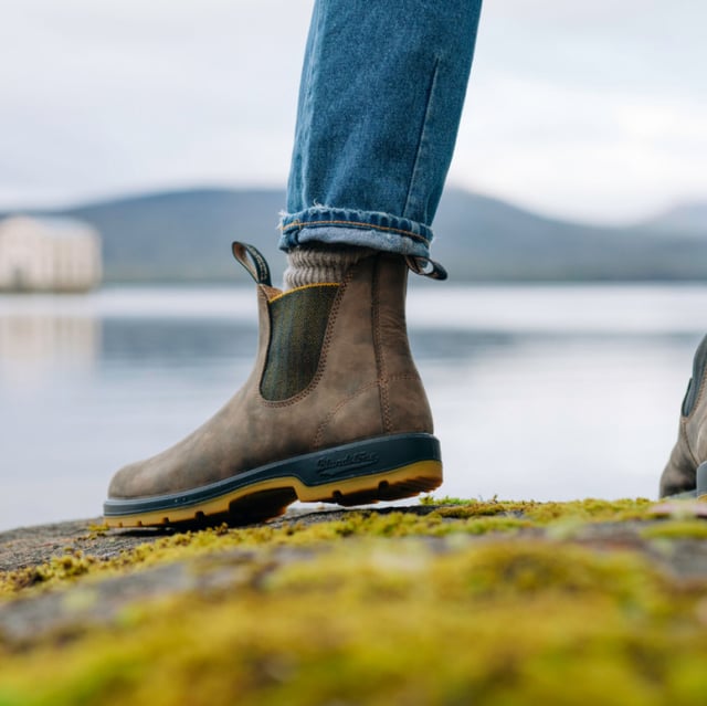 A refresh of the bestselling Blundstone 585 Chelsea boots, the Blundstone 1944s take everything that is great about the original Australian Blundstone boots, and turns it up to max, sacrificing nothing in terms of comfort and function while continuing to look and feel fantastic. With rustic brown water-resistant leather uppers and an eye-catching contrasting TPU sole and mustard accents, the Blundstone 1944s offer a fresh view on classic Blundstone design. A modern take on a timeless classic, these boots are just as much at home in sophisticated urban cityscapes as they are deep in the Australian outback. Comfort is taken to the next level with the removable footbeds and XRD® Technology in the heel for shock absorption, and results in a pair of boots that will come out unscathed from anything you can throw at it.All the durability. More comfort. More shock absorption. More places to see in your Blundstone 1944 boots.  Built for adventures with water resistant, 2.5mm thick premium rustic brown leather uppers Brown herringbone elasticated sides and iconic pull tags for easy slip-on Leather lined for comfort Highly durable TPU outsole ensures that the boot can take a beating Cushioned midsole for all-day comfort Blundstone SPS Max Comfort system for superb shock absorption of up to 90% Extra set of footbeds so you can find your best fit Lightweight for all-day comfort, everyday