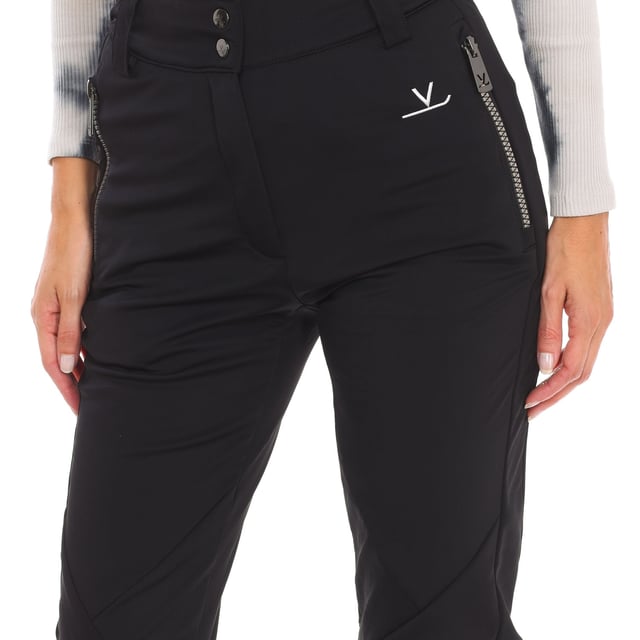 Ski pants Vuarnet.
 Front opening with zipper and snap button.
 Two zippered hand pockets
 Adjustable lower leg with zipper.
 Fixed inner gaiter with non-slip bands and reinforced material on the leg.
 Brand logo on the back.
 Seams seen in tone.
 Composition: 76% Polyamide, 24% Elastane
 Care:
Handwash.
 Do not use dryer.
 Do not iron.
 Do not use bleach.
 Do not dry clean.