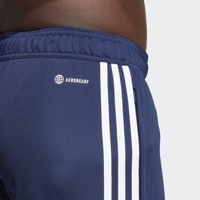 Essential training gear from adidas. Before you hit the pitch for that chilly winter session, layer up in these Tiro 23 Club football pants. Their slim, streamlined fit and moisture-absorbing AEROREADY will keep you flying through sprints and rondos. Once you reach perfect temperature, ankle zips make pulling them off over your boots a breeze.Made with 100% recycled materials, this product represents just one of adidas' solutions to help end plastic waste.  - Slim fit with mid rise - Elastic waist with drawcord - 100% polyester (recycled) - AEROREADY - Side zip pockets - Ankle zips  Shipped by adidas