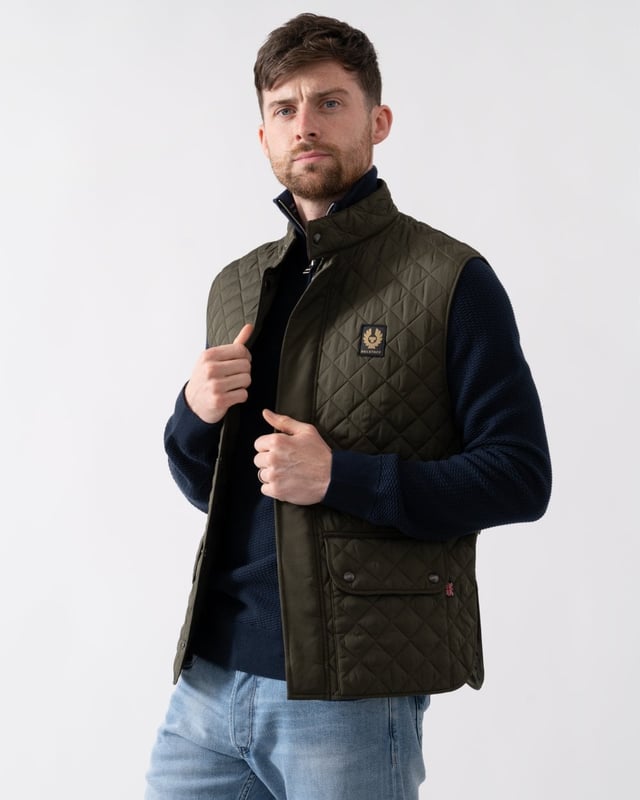 The Icon Gilet in gunmetal. A diamond-quilted padded vest that can be snapped into the Trialmaster and Fieldmaster jackets to add a warming mid-layer.

Quilted recycled nylon
Snaps into the Trialmaster, Trialmaster Panther Jacket and Fieldmaster Jacket
Soft corduroy collar
Belstaff phoenix patch
Press-stud collar fastening
Snap-fastening waist adjustors
Two large lower press-stud pockets
Recycled polyester

Shell: 100% polyester, Lining: 100% polyester, Filling: 100% polyester
105295