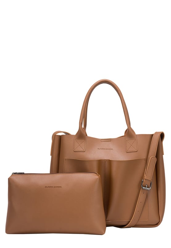 Be anything but basic with this classic wardrobe staple. The Megan XL Tote is the perfect accessory for making a statement and is highly functional too. Inside is a spacious compartment, big enough to carry the days essentials. You can also find a pouch which can be removed, ideal for storing items you want to keep extra secure, or use it as a mobile makeup bag! You have a choice of styling with the tote grab handles and the adjustable shoulder strap, so you can change your look depending on your chosen style! Features: , Lightly textured PU exterior, Claudia Canova debossed logo, Magnetic clasp fastening, Two exterior slip pockets, 2 x tote grab handles, Adjustable shoulder strap, Interior pouch which can be removed using the snap button clasps, Pouch measurement: W 304 x H 203 x D 63 mm, Zip top fastening on interior pouch Style Ref: 84607 TAN