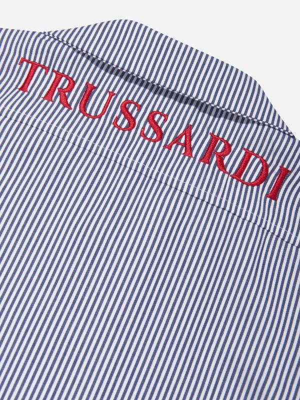 Introducing Trussardi's Boys Copren Short Sleeve Shirt in Navy in Blue, a fusion of designer luxury with kiddie comfort. Essential features: Exquisite Design: The shirt boasts a sophisticated navy blue shade, perfect to style up your young gentleman's casual or special occasion look. Top-Notch Material: Crafted from best grade fabric, it ensures plush comfort throughout the day, making it ideal for the playful nature of boys. Unique Print: The trendy print gives this shirt a fun and quirky edge that will make your boy stand out and enjoy his sartorial choices. Trussardi Charm: Let your boy bask in the high-end elegance of Trussardi, a brand synonymous with style and superior quality. Order this wardrobe must-have today!