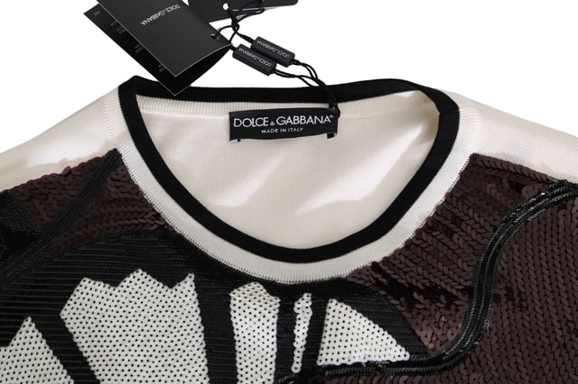 Varumärke: Dolce \u0026 Gabbana\n  Pullover-stil\n  Rund halsringning\n  Färg: Vit och svart med flerfärgade paljetter\n  Kollektion: New York Jazz Guitar\n  Logotypdetaljer\n  Tillverkad i Italien\n  Material: 68% silke 27% polyester 5% nylon\nMaterial: 68% silke 27% polyester 5% nylon