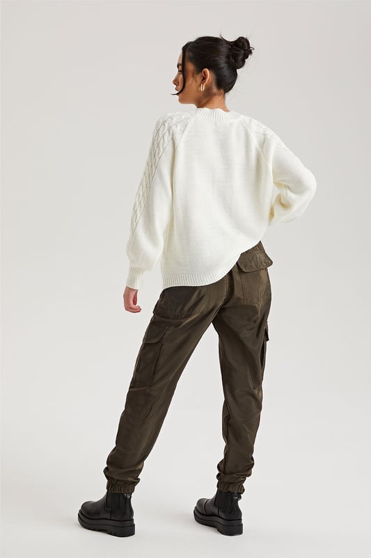 Model is 5'6 and wears a size S.Pockets. Drawstring waist band. Cuff hem. Introducing our Khaki Parachute Cargo Trouser, a versatile and stylish addition to your wardrobe that effortlessly combines functionality with fashion-forward design. Crafted with attention to detail and quality, this cargo is perfect for those who seek comfort without compromising on style.