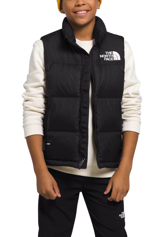 The North Face Nuptse has been delivering game-changing warmth since 1992 and no other jacket has journeyed so naturally from the mountains to city streets. - - .   The Teens' 1996 Retro Nuptse Gilet is a modern reincarnation of the icon, built for young adults. - - .  We’ve kept most things the same: the same boxy silhouette; the same shiny ripstop fabric; the same exposed zip and diagonal hand pockets and, of course, the same oversized baffles. - - .  The only change is upgrading to 700-fill of responsibly sourced down. - - .  It's also made with recycled materials, making it kinder to nature. - - . Shell: 100% Nylon, Lining: 100% Polyester, Filling: 90% Down, 10% Waterfowl Feathers.